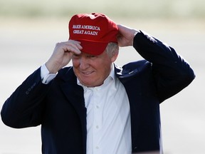 In this June 1, 2016, file photo, Republican presidential candidate Donald Trump wears his "Make America Great Again" hat at a rally in Sacramento, Calif. Trump enters the White House on Jan. 20 just as he entered the race for president: defiant, unfiltered, unbound by tradition and utterly confident in his chosen course. (AP Photo/Jae C. Hong, File)
