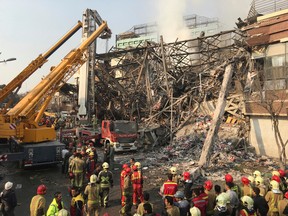 Iranian firefighters work at the scene of the collapsed Plasco building after being engulfed by a fire, in central Tehran, Iran, Thursday, Jan. 19, 2017. A high-rise building in Tehran engulfed by a fire collapsed on Thursday as scores of firefighters battled the blaze. (AP Photo/Ebrahim Noroozi)