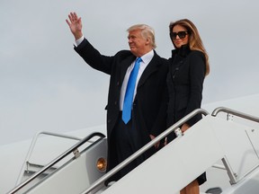 President-elect Donald Trump, accompanied by his wife Melania Trump, waves as they arrive at Andrews Air Force Base, Thursday, Jan. 19, 2017, in Andrews Air Force Base, Md. (AP Photo/Evan Vucci)