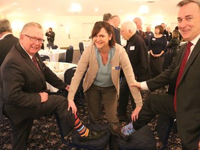 BRUCE BELL/THE INTELLIGENCER
Prince Edward County Chamber of Tourism and Commerce executive director Emily Cowan checks the socks of Mayor Robert Quaiff (left) and Bay of Quinte MP Neil Ellis at Thursday morning’s Breakfast Briefing with the Mayor at the Waring House. The two politicians have a standing joke about who wears the nicest socks.