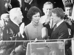 Democrat Jimmy Carter is sworn in by chief justice Earl Burger as the 39th president of the United States while first lady Rosalynn looks on, Washington DC, January 20, 1977. (Photo by Hulton Archive/Getty Images)