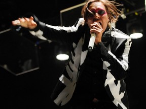 Win Butler of Arcade Fire performs during their headlining set on the third day of the 2014 Coachella Music and Arts Festival in Indio, Calif. in this April 13, 2014 file photo. (THE CANADIAN PRESS/AP- Photo by Chris Pizzello/Invision/AP, File)