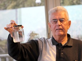 Dover Township, Ont resident Peter Hensel displays a sample of his well water that was recently test, which showed higher levels of arsenic, barium, lead, selenium and uranium than when it was tested in 2012. Photo taken on Thursday January 19, 2017. (Ellwood Shreve/Chatham Daily News)