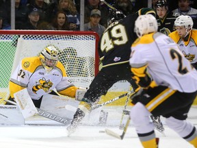 Max Jones of the Knights gets ready to flip the puck over Sting goaltender Justin Fazio for the first goal of the game during the first period of their game Wednesday night at Budweiser Gardens in London, Ont. (MIKE HENSEN, The London Free Press)