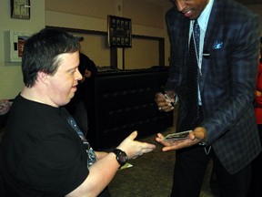 Doug Craik, 46, asks former Toronto Raptor Jerome "Junkyard Dog" Williams for an autograph Thursday afternoon at the 39th annual St. Thomas Sports Spectacular. The celebrity meet-and-greet, dinner and silent auction at the St. Anne's Centre raises money for the Special Olympics and Community Living Elgin.