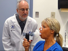 Dr. Shawn Aaron gives a patient a spirometry test. (The Canadian Press)