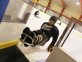 Colby Clatworthy, 26, demonstrates how he gets over a lip between the ice and the players' bench at Clearwater Arena, at a recent practice for the Sarnia Ice Hawks. The ice has already been raised once, and more work is underway to make the arena more accessible. (Tyler Kula/Sarnia Observer)