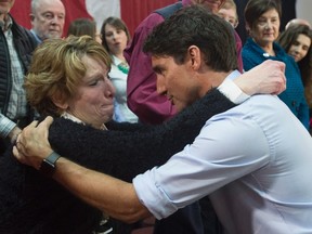 Prime Minister Justin Trudeau speaks with an emotional Kathy Katula, from Buckhorn, Ont. following a news conference in Peterborough earlier this month. Katula has come to symbolize the economic struggles of Canadians. (Adrian Wyld/The Canadian Press)