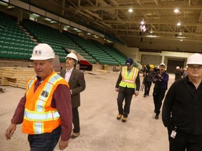 JASON MILLER/The Intelligencer
Gary Hauck of Ball Construction (first left) and city project manager Peter Lyng lead a tour of Yardmen Arena.