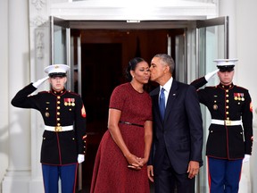 President Barack Obama gives Michelle Obama a kiss as they wait for President-elect Donald Trump and wife Melania at the White House before the inauguration on Jan. 20, 2017 in Washington, D.C. (Kevin Dietsch-Pool/Getty Images)