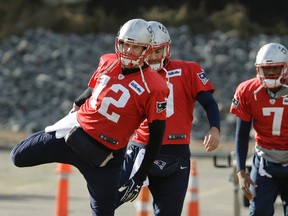 New England Patriots quarterbacks Tom Brady, left, Jimmy Garoppolo, center, and Jacoby Brissett, right, warm up during an NFL football team practice, Thursday, Jan. 19, 2017, in Foxborough, Mass. The Patriots host the Pittsburgh Steelers in the AFC championship game Sunday. (AP Photo/Steven Senne)