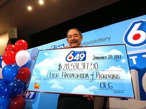 Peter Hayashida, of Pickering, collects his $20-million Lotto 6/49 prize in Toronto on Friday, January 20, 2017. (Michael Peake/Toronto Sun)