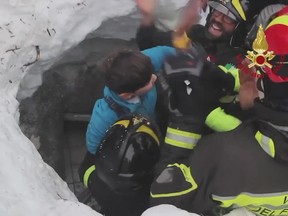 This frame from video shows Italian firefighters extracting a child alive from under snow and debris of an hotel that was hit by an avalanche on Wednesday, in Rigopiano, central Italy, Friday, Jan. 20, 2017. (Italian Firefighters/ANSA via AP)