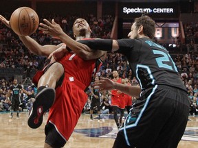 Raptors' Kyle Lowry (left) is fouled by Hornets' Marco Belinelli (21) during first half NBA action in Charlotte, N.C., on Friday, Jan. 20, 2017. (Chuck Burton/AP Photo)