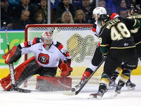 Sam Miletic of the Knights misses the bouncing puck as he closes on Oliver Lafreniere of the Ottawa 67's during their game at Budweiser Gardens in London, Ont. on Friday January 20, 2017. (MIKE HENSEN, The London Free Press)