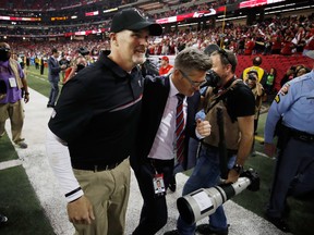Falcons head coach Dan Quinn celebrates a win with GM Thomas Dimitroff against the Seahawks at the Georgia Dome in Atlanta on Saturday, Jan. 14, 2017. (Gregory Shamus/Getty Images)