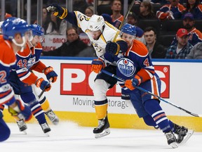 Edmonton Oilers' Kris Russell collides with Nashville Predators' Craig Smith at Rogers Place in Edmonton on Friday, Jan. 20, 2017. (Ian Kucerak)