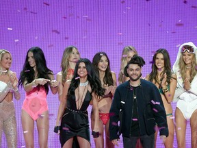 Singers Selena Gomez, and The Weeknd walk the runway with Victoria's Secret models during the 2015 Victoria's Secret Fashion Show at Lexington Avenue Armory on November 10, 2015 in New York City. (Photo by Jamie McCarthy/Getty Images)