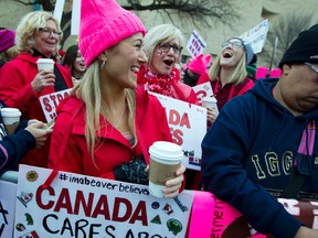 Women with bright pink hats and signs begin to gather early and are set to make their voices heard on the first full day of Donald Trump’s presidency, Saturday, Jan. 21, 2017 in Washington. (AP Photo/Jose Luis Magana)