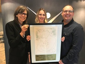 Dr. Penny Sutcliffe, left, Sudbury & District Medical Officer of Health, Nicole Stewart, public health nurse, and René Lapierre, chair of the  Sudbury & District Board of Health, display artwork and a plaque during a presentation to the Sudbury & District Health Unit by the Breastfeeding Committee of Canada in recognition of achieving ‘Baby-Friendly’ status. Supplied photo