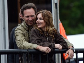 Geri Halliwell cuddles up to new husband Christian Horner at the Isle of Wight Festival as they watch the main stage. (WENN.COM)