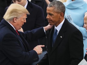 U.S. President Donald Trump speaks with former president Barack Obama after his speech during the 58th Presidential Inauguration at the U.S. Capitol in Washington, Friday, Jan. 20, 2017. (AP Photo/Andrew Harnik)