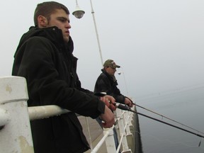 Micky Gatt, of Corunna, and Tanner Moyer, of Sarnia, fish on Saturday January 21, 2017 in the St. Clair River at Sarnia, Ont. The International Joint Commission is seeking public input on its draft report assessing progress Canada and the U.S. are making to restore and protect the Great Lakes.
Paul Morden/Sarnia Observer/Postmedia Network
