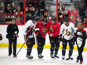 Clarke MacArthur is helped off the ice after suffering a concussion during training camp. (POSTMEDIA NETWORK)
