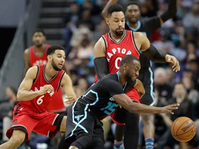 Raptors teammates Cory Joseph (6) and Jared Sullinger (0) try to stop Kemba Walker (15) of the Hornets during NBA action at Spectrum Center in Charlotte, N.C., on Friday, Jan. 20, 2017. (Streeter Lecka/Getty Images)