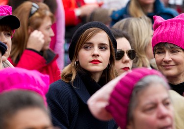 Actress Emma Watson sit with the crowd during the Women's March on Washington, Saturday, Jan. 21, 2017 in Washington. (AP Photo/Jose Luis Magana)
