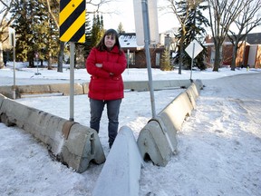 Belgravia resident Debby Waldman is upset about a neighbourhood renewal project planned for Belgravia in the spring and summer of 2017, the city has put up barriers extending a curb near 116 Street and 77 Avenue. According to city officials, the barriers are to test the placement of the curb in an attempt to make it safer for pedestrians to cross. However local residents say the intersection isn't an issue for pedestrians, but the concrete barriers they put up definitely are. (Photo by Larry Wong/Postmedia Network)