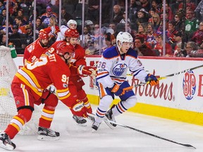 Sam Bennett #93 of the Calgary Flames chases the puck against Drake Caggiula #36 of the Edmonton Oilers during an NHL game at Scotiabank Saddledome on January 21, 2017 in Calgary, Alberta, Canada.