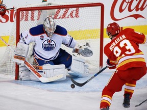 The Calgary Flames' Sean Monahan shoots at Edmonton Oilers goaltender Laurent Brossoit in the third period of NHL action at the Scotiabank Saddledome in Calgary on Saturday January 21, 2017.