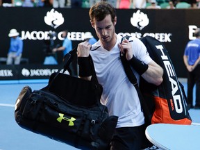 Andy Murray carries his bags from the court following his fourth-round loss to Mischa Zverev at the Australian Open in Melbourne Sunday, Jan. 22, 2017. (AP Photo/Mark Baker)