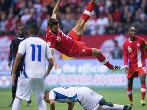 Canada's Adam Straith (top centre) is sent flying after colliding with El Salvador's Roberto Dominguez during CONCACAF World Cup qualifying action in Vancouver on Sept. 6, 2016. During a friendly against Bermuda on Sunday, Canada had to turn to Straith in net for the final 35 minutes due to the starting goalkeeper's injury. (Darryl Dyck/The Canadian Press/Files)