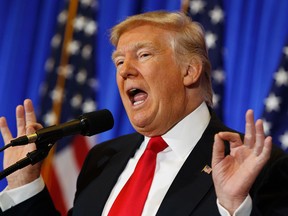 In this Jan. 11, 2017 file photo, President-elect Donald Trump speaks during a news conference in the lobby of Trump Tower in New York. Trump says his team will have a “full report on hacking within 90 days,” and is again dismissing as fake a document alleging Russia has damaging information about him. (AP Photo/Evan Vucci)