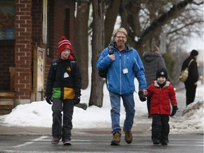 David Loehr walks to Hopewell Avenue Public School with his sons Spencer (L) and Adam. Friday January 20, 2017. Errol McGihon/Postmedia