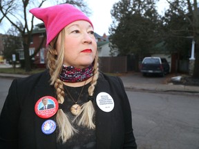 Gena Brumitt, chair of Democrats Abroad for the London area wears buttons from the women?s march in Washington, D.C. She says the protests are just the beginning. (MIKE HENSEN, The London Free Press)
