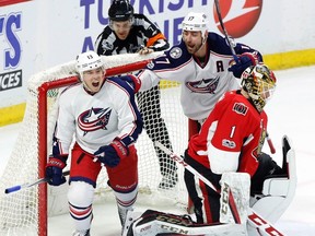 Blue Jackets' Cam Atkinson (13) celebrates his overtime goal with teammate Brandon Dubinsky (17) as Senators goaltender Mike Condon looks on during NHL action in Ottawa on Sunday, Jan. 22, 2017. (Fred Chartrand/The Canadian Press)