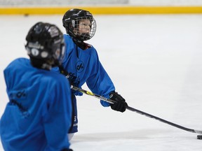 Hockey player and cancer survivor Ethan Hughes, 10, (right) practices with the Whitemud West Atom Badgers at Oliver Arena in Edmonton on Saturday, January 21, 2017. Ian Kucerak