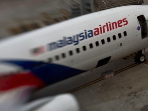 This file photo taken with a tilt and shift lens on June 16, 2014 shows a Malaysia Airlines plane parked on the tarmac at Kuala Lumpur International Airport in Sepang. The official search for MH370 may have been called off but experts believe the missing airliner will one day be found, perhaps either by deep-sea miners or treasure hunters lured by a huge cash reward. After spending almost three years and 150 million USD on a deep sea hunt for the Malaysian passenger jet in the remote Indian Ocean off western Australia, top aviation investigators have been forced to admit they have come up with nothing. (AFP PHOTO / MANAN VATSYAYANA)