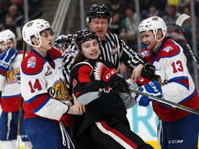 Edmonton Oil Kings' Davis Murray (14) grabs Moose Jaw's Matt Sozanski as he chips at Nick Bowman at Rogers Place in Edmonton on Sunday, Jan. 22, 2017. (Ian Kucerak)