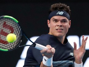 Canada’s Milos Raonic hits a forehand to Roberto Bautista Agut during their fourth-round match at the Australian Open in Melbourne Monday, Jan. 23, 2017. (AP Photo/Dita Alangkara)
