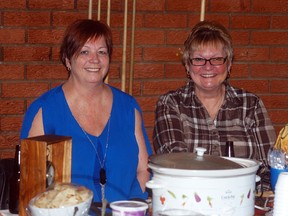 Michelle Bea, left, and Cheryl Byrne are all smiles as they take part in the Wallaceburg Red Devils chili cookoff held at the CBD Club on Saturday. A total of 11 teams entered chili into the event. Gary Moreland's chili won the judges choice, with Darryl Williams coming in second place and Bill Hudson in third. The ‘Three Amigos’ won for best decorated booth, while the People’s Choice chili winner was Chris Dawson.