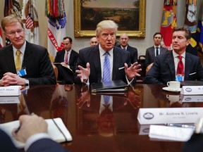 President Donald Trump speaks while hosting a breakfast with business leaders in the Roosevelt Room of the White House in Washington, Monday, Jan. 23, 2017. At left is Wendell P. Weeks, Chief Executive Officer of Corning, at right is Alex Gorsky Chairman and Chief Executive Officer of Johnson & Johnson. (AP Photo/Pablo Martinez Monsivais)