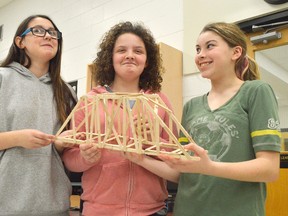 From left, McKenna Morrison, Laney Burke, and Carley Ruelland present the winning structure from their bridge-building competition at Gregory Drive Public School Jan. 18. It will go on display at Lambton Mall in late March before taking part in a region-wide competition.