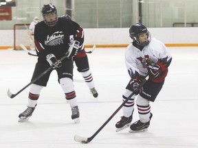 Bantam Hawk Reid Liebreich looks to make a pass during a game at the Vulcan District Arena on Saturday evening, when Vulcan played a Lethbridge team.