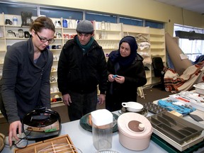 KEYS Job Centre volunteer Emma Jackson helps Syrian refugees Marwan and Magida Ali shop for household items at the former Blockbuster Video location at 226 Queen St. in Kingston on Thursday January 19 2017. Ian MacAlpine /The Whig-Standard/Postmedia Network
