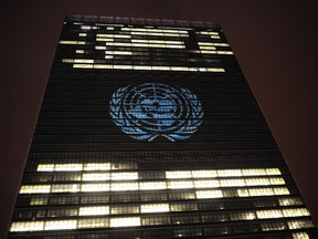 The UN logo is projected onto the United Nations headquarters before a video by French musician David Guetta is projected on it in support of 'The World Needs More' campaign in New York on November 22, 2013.(EMMANUEL DUNAND/AFP/Getty Images)