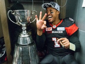 Redblacks QB Henry Burris celebrates with the Grey Cup in November in Toronto. (Craig Robertson/Postmedia Network)